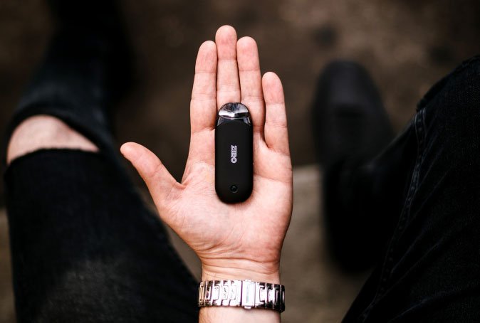 Person Holding Black Vape in Palm of Hand 1