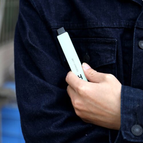 Man wearing Denim Jacket Holding a Vape